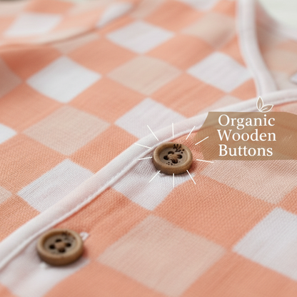 Checkered fabric with organic wooden buttons on a soft focus background
