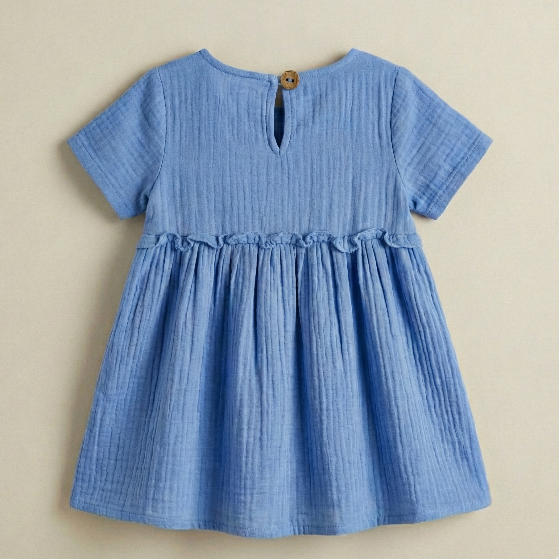 Blue dress on a beige background