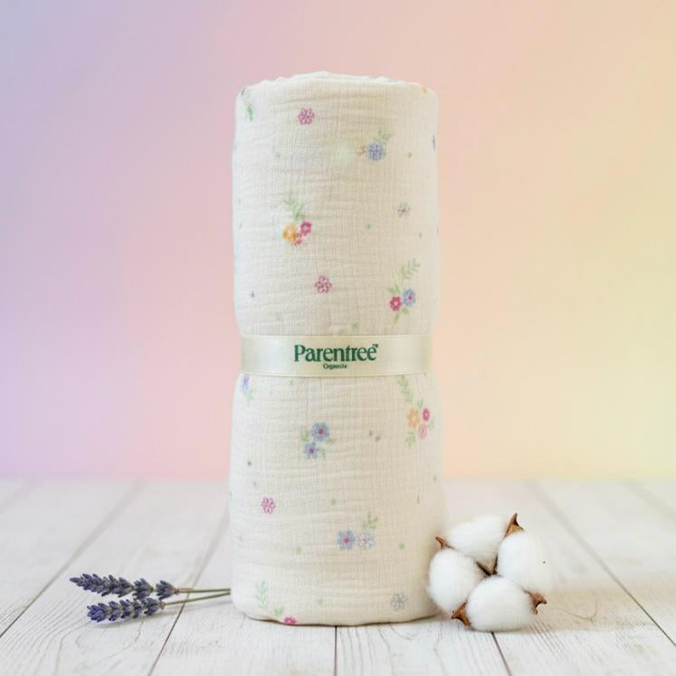 Roll of fabric with floral pattern and 'Parentree' branding on a wooden surface with a pastel gradient background.