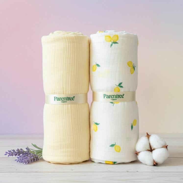 Two rolled-up baby blankets with 'Parentree' branding on a wooden surface with a soft pastel background.